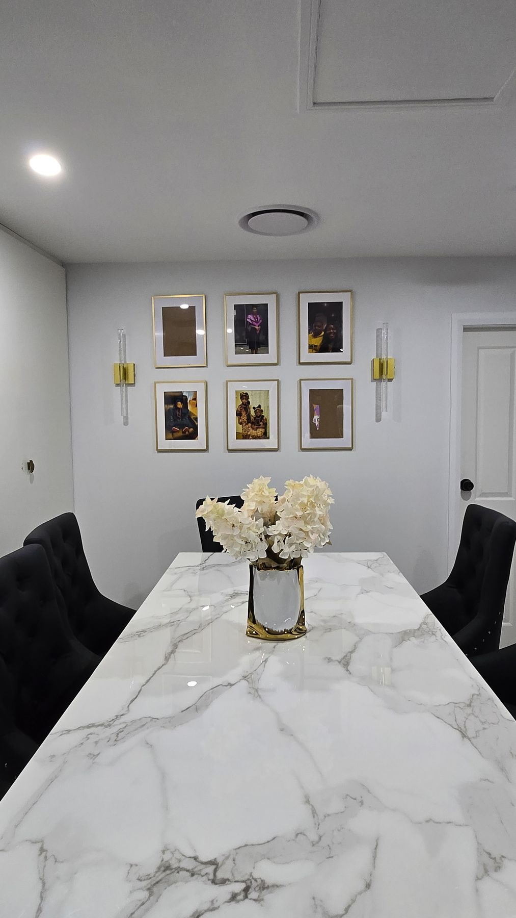 Dining room with gold-framed gallery wall