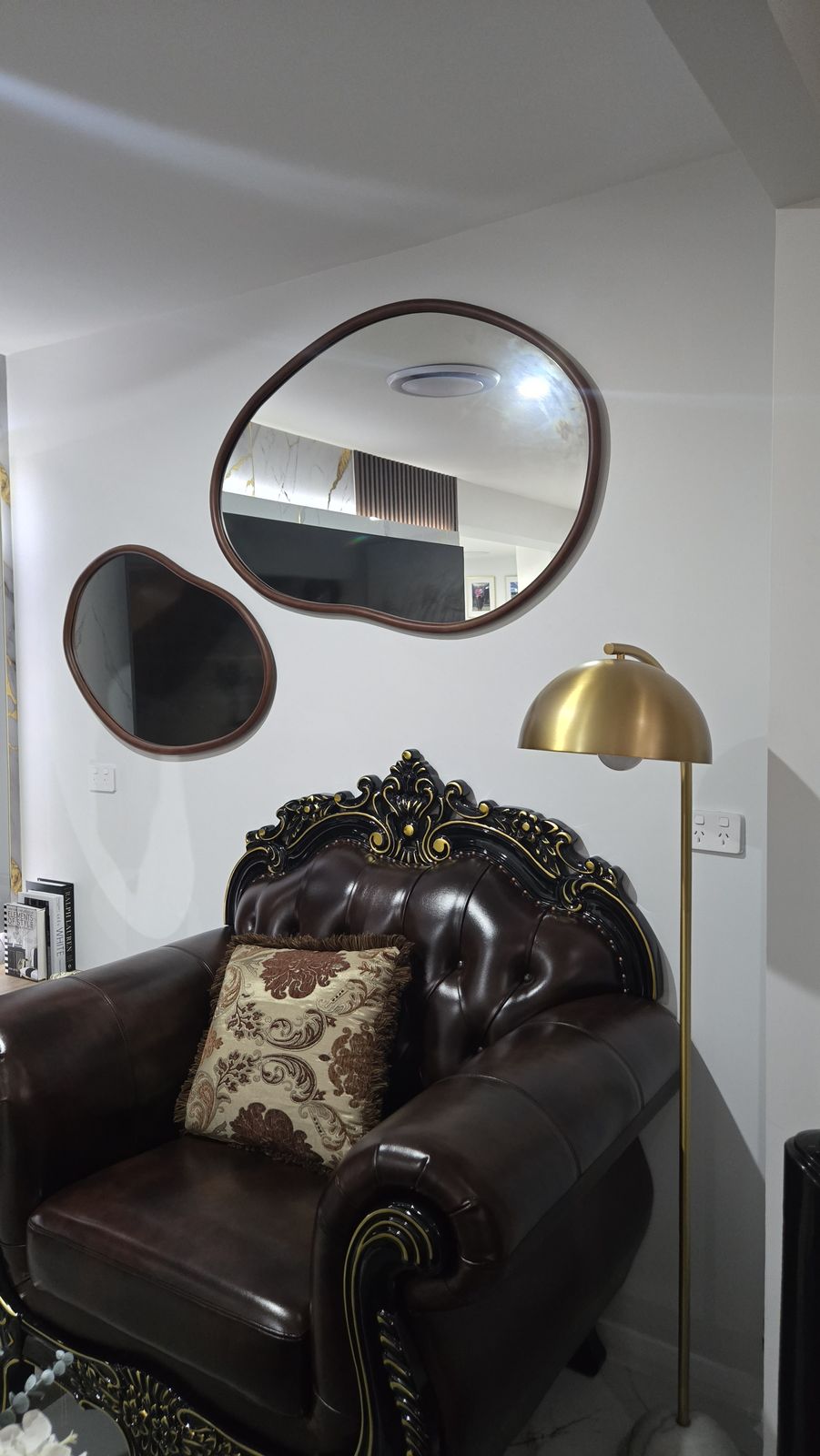 Pebble mirrors beside an ornate armchair