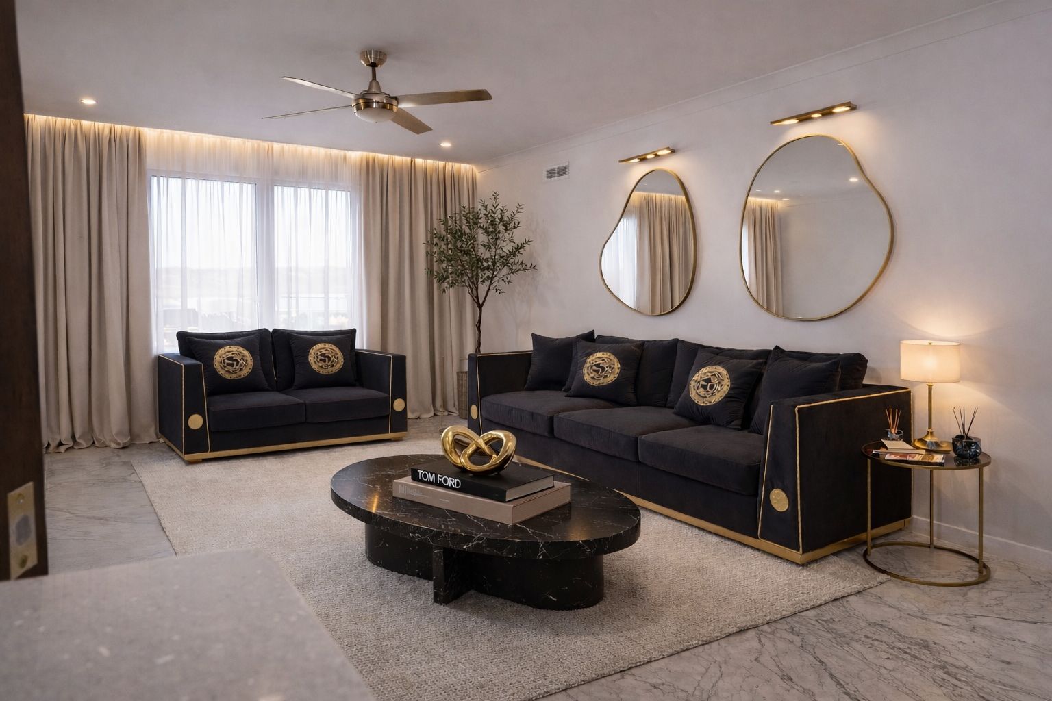 Design vision — black velvet sofas with gold trim and sculptural mirrors